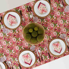 Overhead shot of Spice Route Garnet tablecloth with centerpiece. 