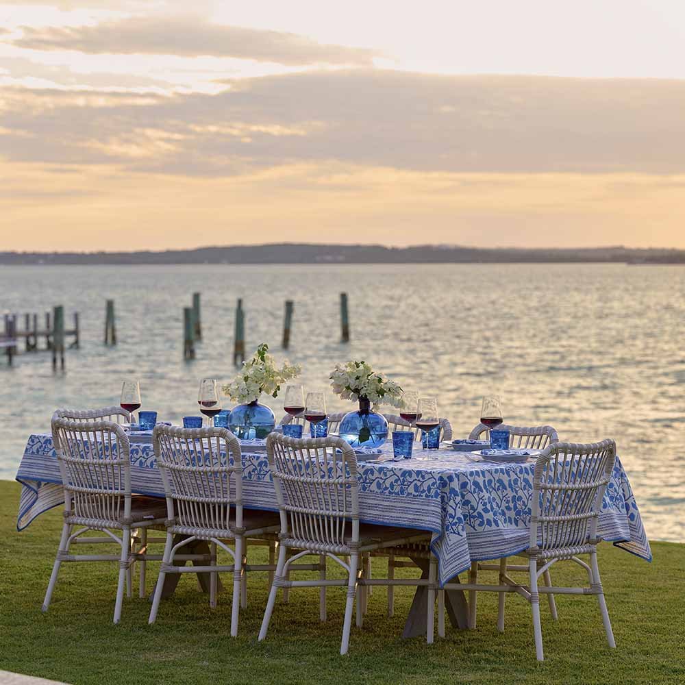 Outdoor table for evening dinner with lake background. 