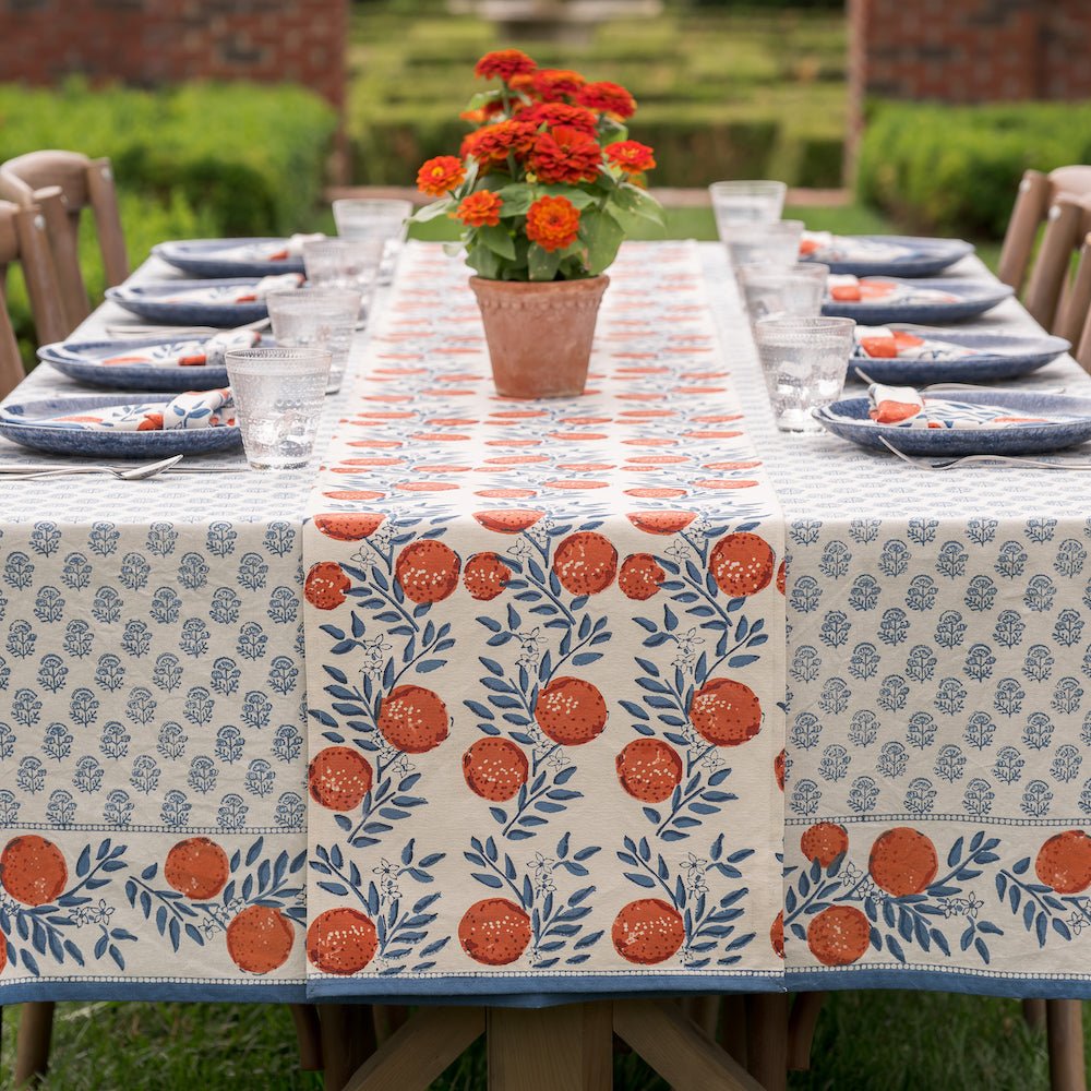 outdoor table with orange grove tablecloth and runner