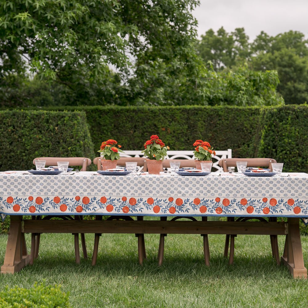 tablecloth on table outside printed with blue florals and oranges
