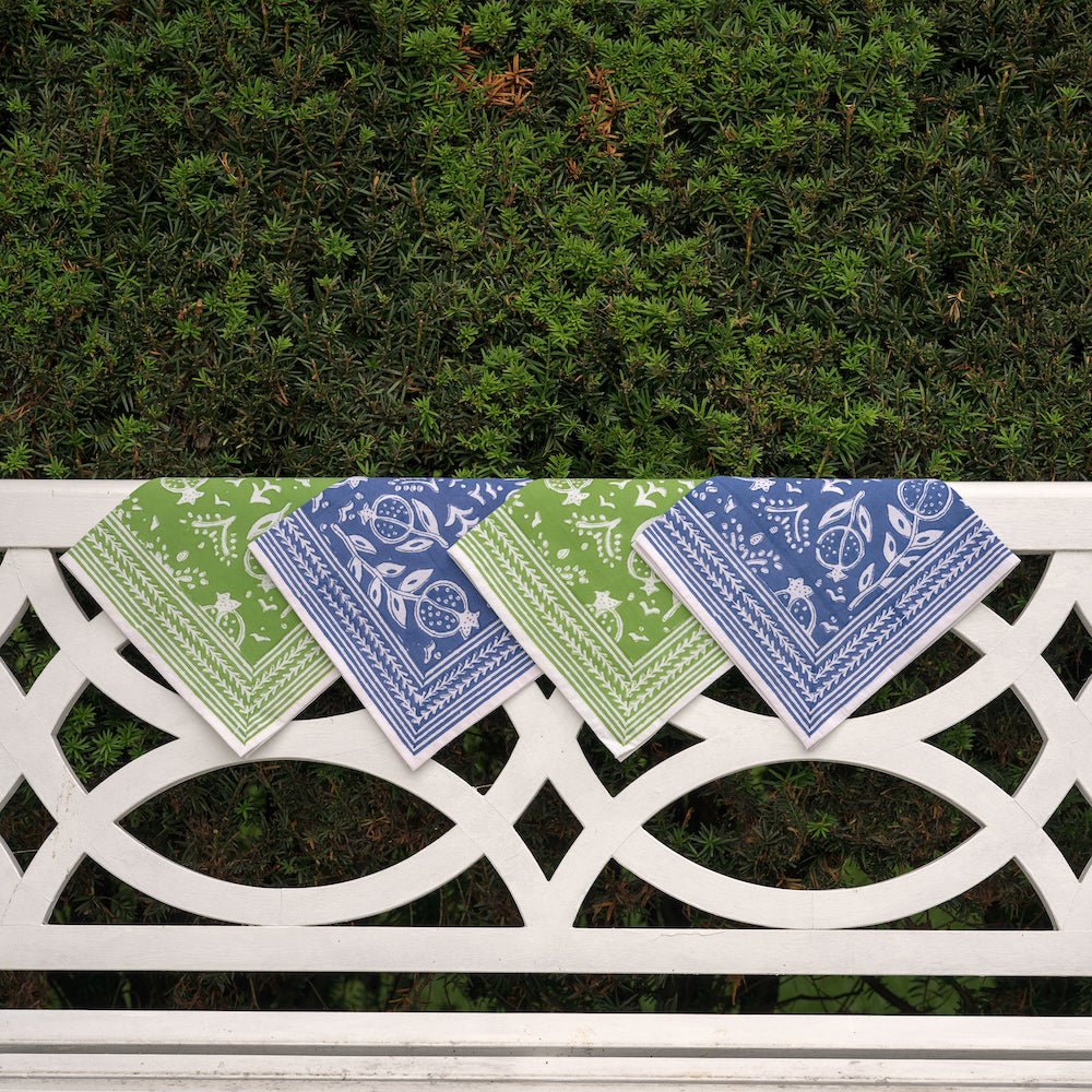 pomegranate blue and green napkins hanging over white bench