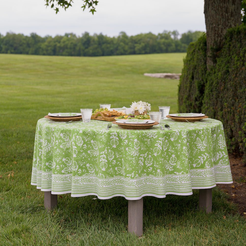 round outdoor table with pomegranate green tablecloth