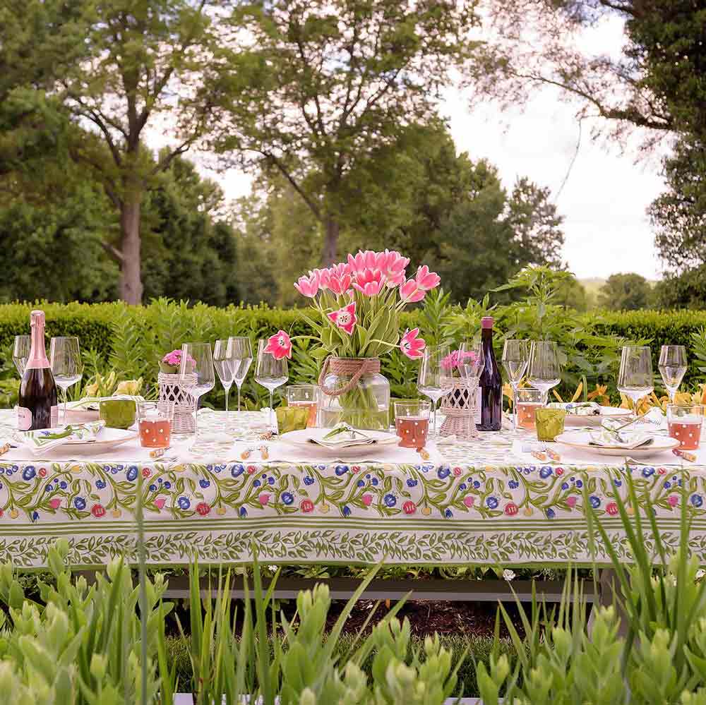 Multi-color floral printed tablecloth in garden setting.