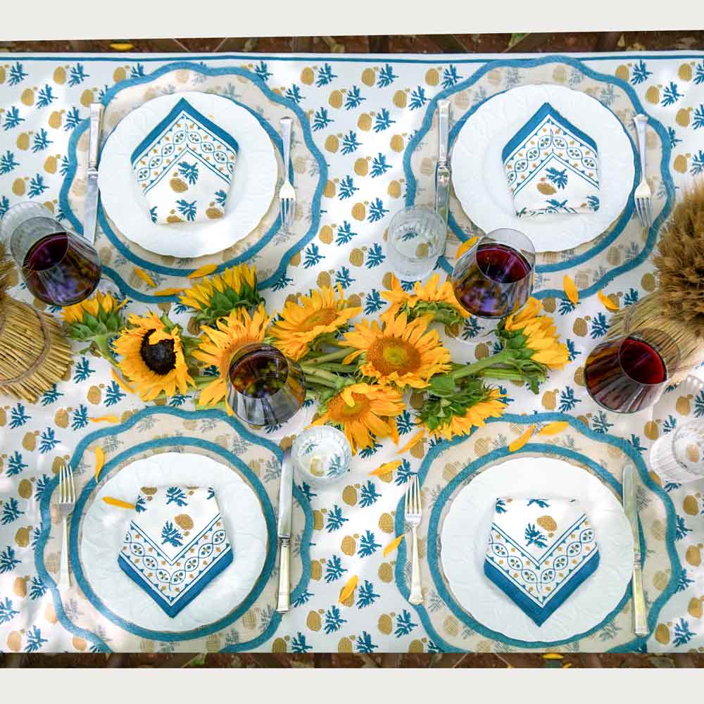 Gaya Teal &amp; Marigold Tablecloth and Napkin set complimented by sunflowers. 