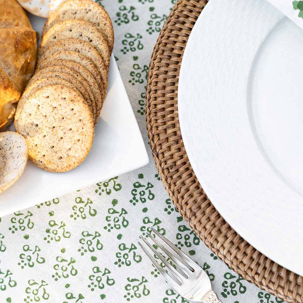 Close up of plate, crackers, and tablecloth. 