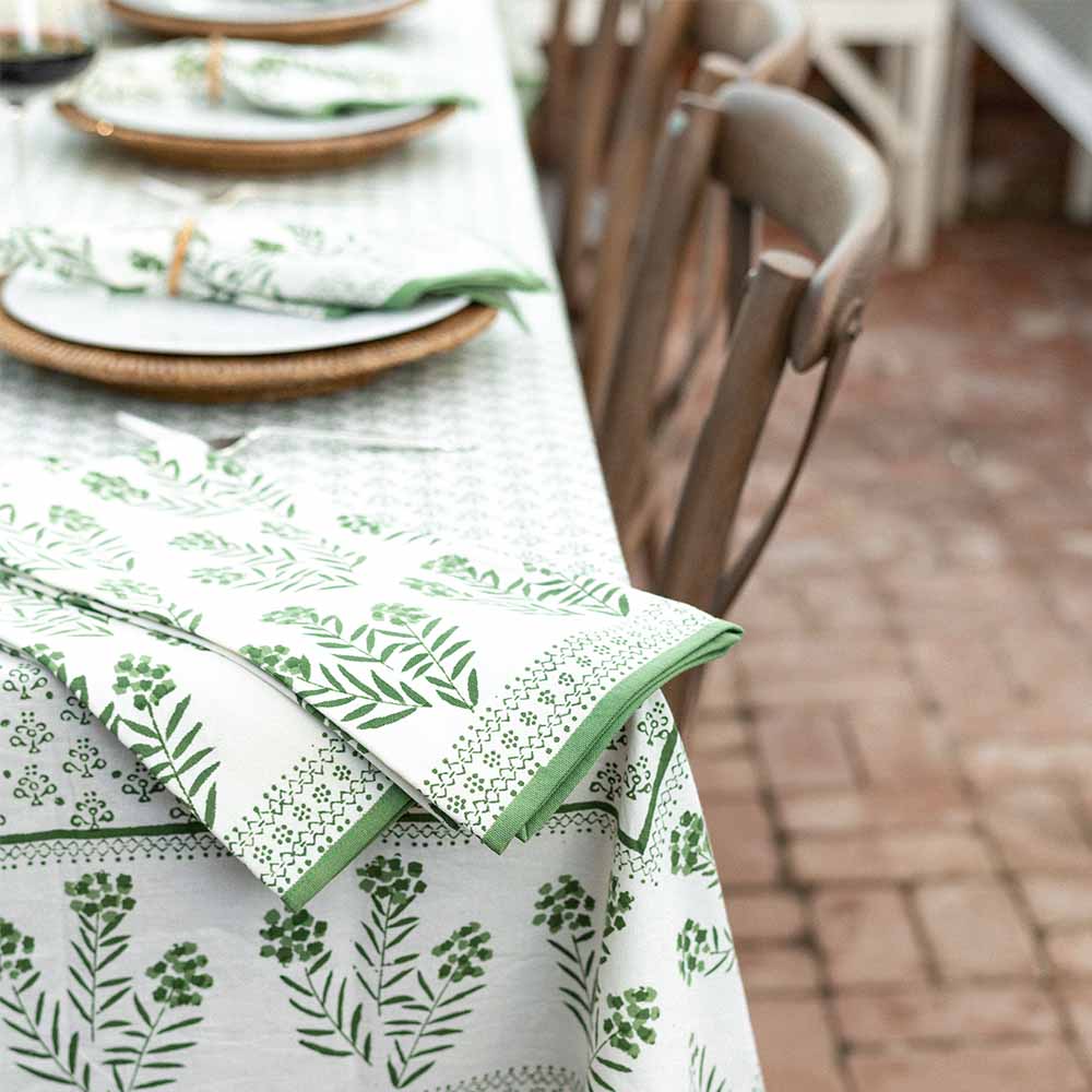 Tea towels on table with matching tablecloth. 