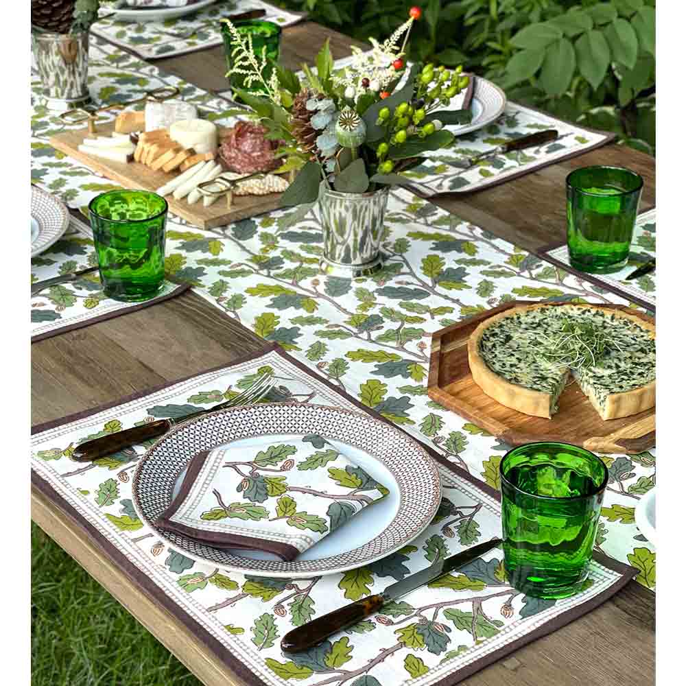 Placemats on dinner table with matching napkins and table runner. 